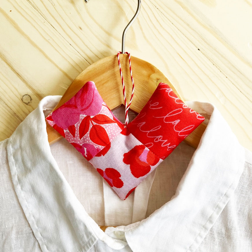jetaime fabric patchwork heart valentines day sewing project hanging off of a clothes hanger